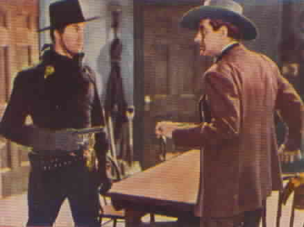 Zorro removes his mask in front of the marshal.