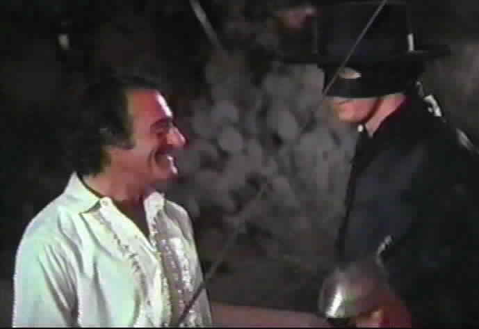 Zorro and Don Alejandro smile at each other.