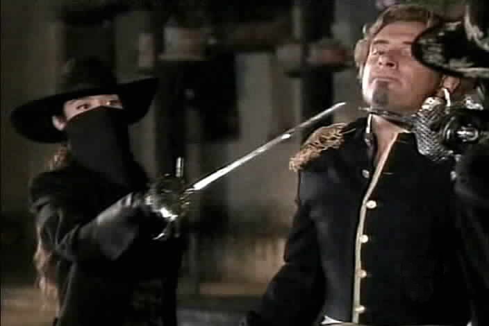Zorro and his unknown accomplice hold their swords to Montero's throat.
