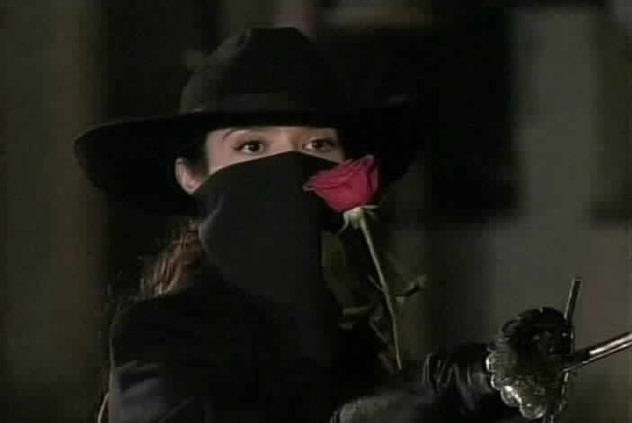 The lady throws Zorro a rose.