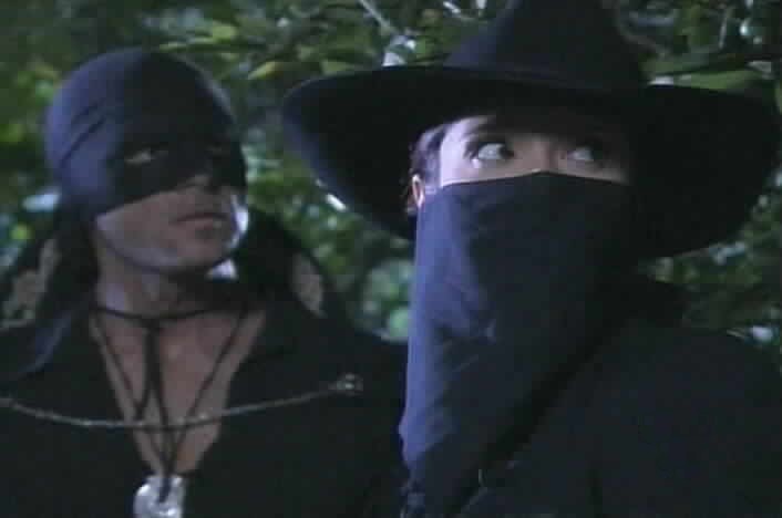 Zorro and Esmeralda stare at Santiago in surprise.