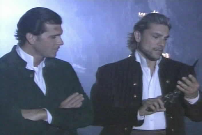 Alejandro examines Zorro's weapons.