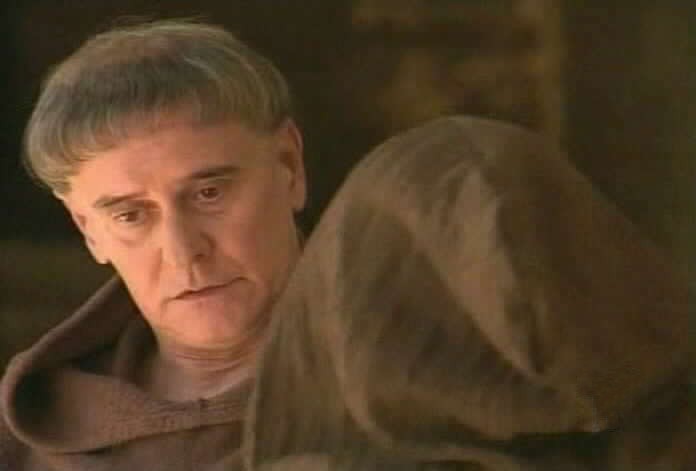 Padre Tomas speaks to a member of the brotherhood.