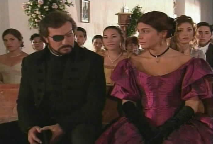 Fernando sits down next to Maria Pia.