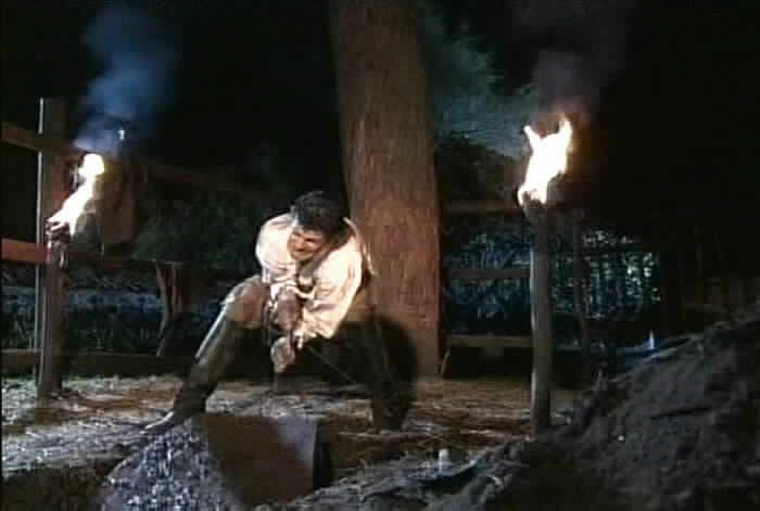 Agapito struggles to pull Sara Kali's coffin out of the grave.