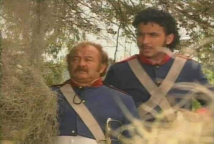 Sgt. Garcia and Aguirre watch the family approach Esmeralda's coffin.