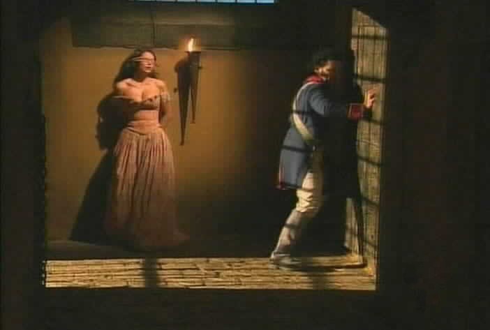 Aguirre opens the secret passage that leads to Esmeralda's cell.
