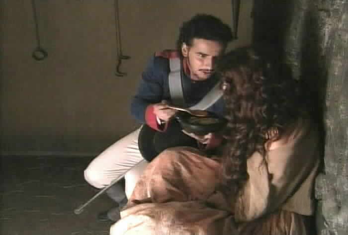 Aguirre gives Esmeralda something to eat.