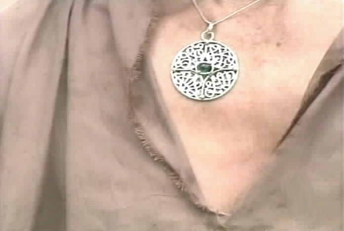 The survivor is wearing Esmeralda's medallion.