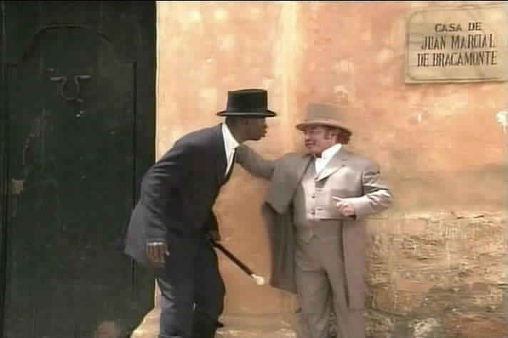 Kamba and Garcia pause outside the Count of Bracamonte's house.